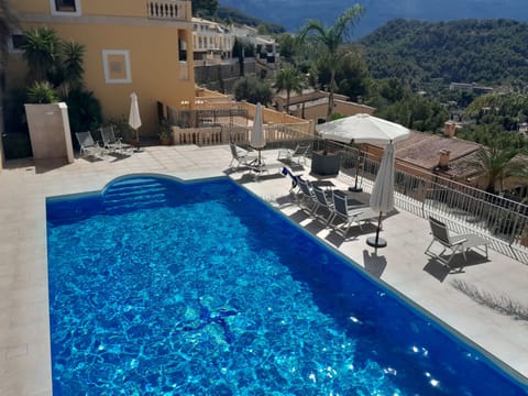 The pool enjoys great mountain views, sun loungers and parasols.