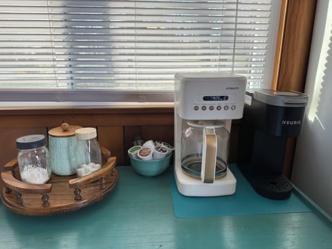 Keurig and drip coffee pot with starter coffee, filters and sugar 
