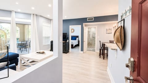 bed, couch, private space, living area, television, dining table