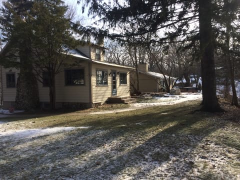 Side of house facing the lake with large grassy area for lawn games.