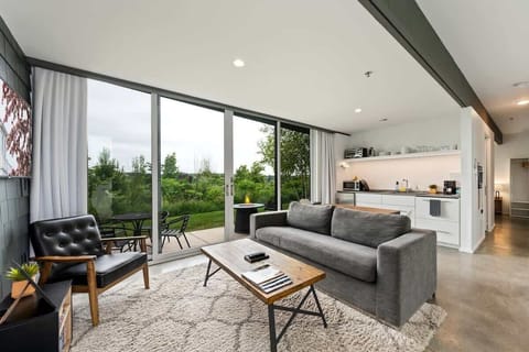 Enjoy open-concept living with sleek finishes, a cozy lounge space, and wall-to-wall views of nature.