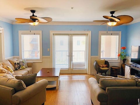 Spacious living area leads to large patio with view of pool.