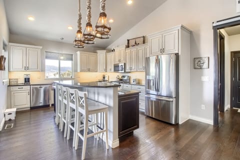 Stainless steel dishwasher, french door refrigerator, gas range and farm sink