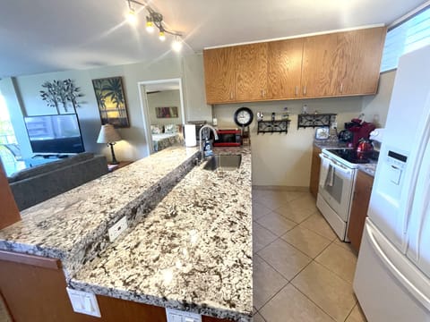Kitchen has granite countertops, microwave, toaster oven, coffee maker, and more