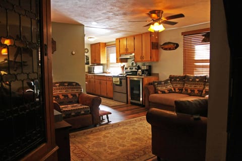 Kitchen with medium inside fridge. Full size freezer/fridge outside in shed. 