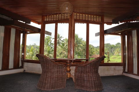 The Balcony sitting area with pool and rice terrace view