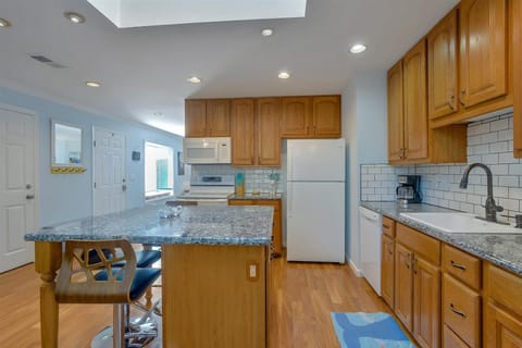The kitchen includes double oven, microwave, dishwasher,  and coffee maker.