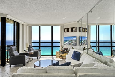 Floor-to-ceiling windows w/ shades that pull all the way back allow great views throughout the living room and kitchen