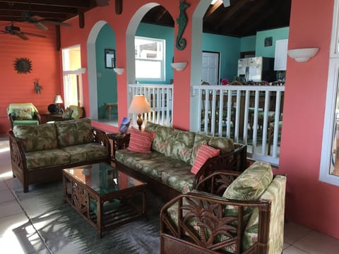 Main living open to dining and kitchen with mahogany cathedral ceilings and fans