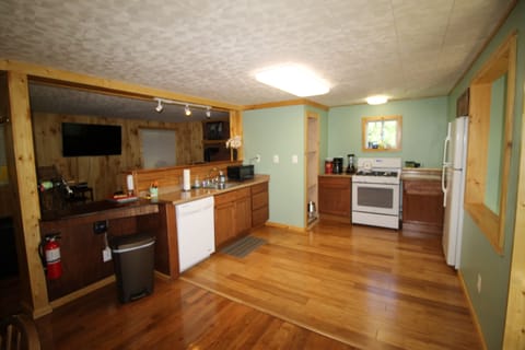 Kitchen Features Dishwasher, Gas Stove and Refrigerator. 