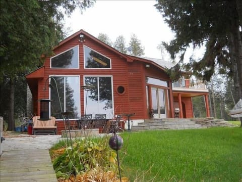 Apple Unit with large windows towards the water, outside patio with a fire pit