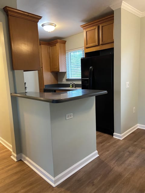 Hall to bedroom on left, dining table to the right.  