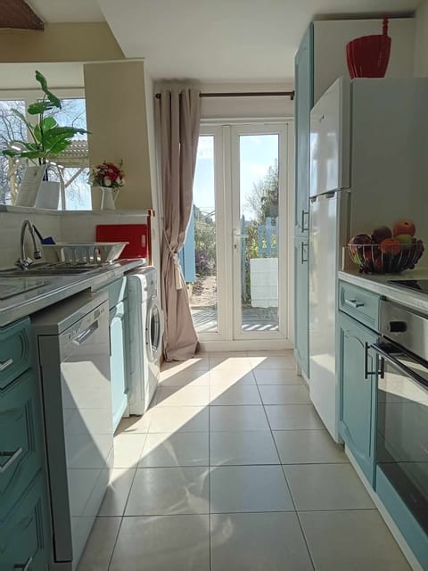 Fully fitted kitchen with patio doors leading to the south facing garden