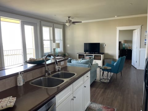 Full size appliances in the galley kitchen that is open to living area.