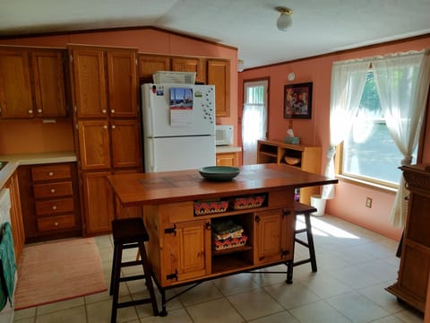 Kitchen Island, hallway leading to primary suite with private bath