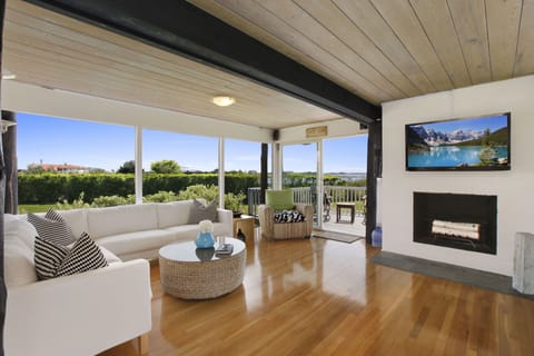 Bright and sunny living room. Working fireplace. Comfortable couches. 