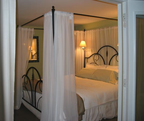 the master bedroom has a romantic King size four poster bed