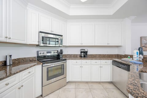 Inviting kitchen featuring stainless appliances and elegant granite countertops, perfect for culinary adventures