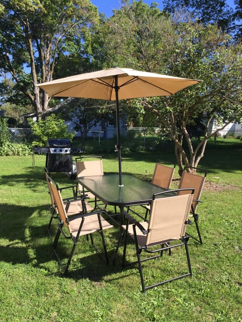 New backyard patio set for six. Includes umbrella. Also a new gas grill. 