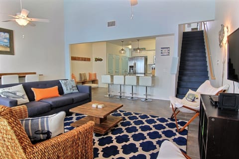 Living room, kitchen and stairs leading to second floor.