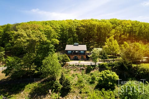 This secluded mountainside estate boasts panoramic Hudson River views.