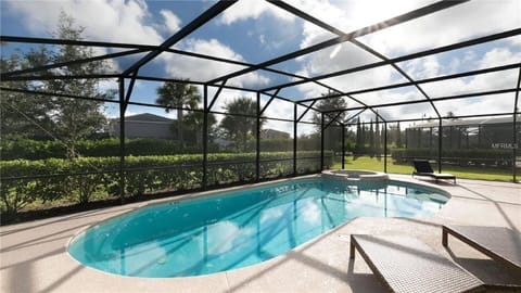 Beautiful pool deck with loungers, sofa seating, dining area, pool safety fence