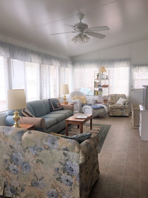 living room with two sleep sofas, two rocking chairs and a lounger