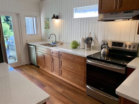 Remodeled kitchen opens up to deck overlooking the river.