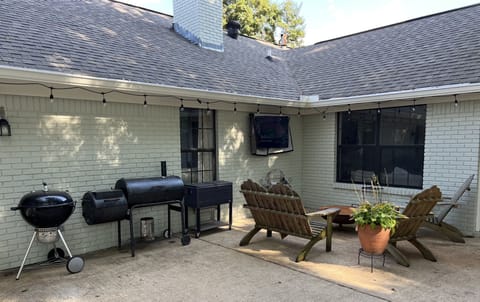 The back patio has a fire pit, grills, and TV to enjoy during the evenings.