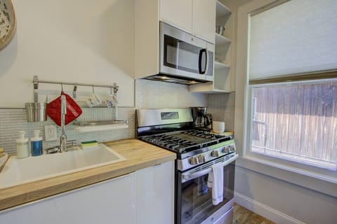 Cozy kitchen equipped with a full stove, microwave, and coffee maker—perfect for cooking at home or enjoying your morning brew.