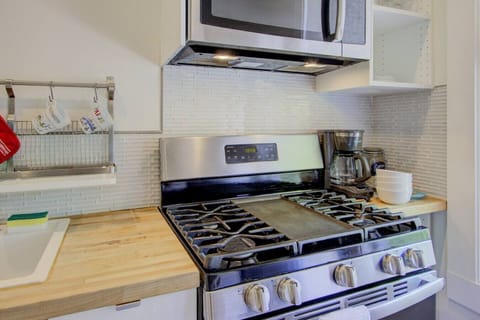 A handy kitchen awaits with appliances for cooking, reheating, and brewing your morning coffee.