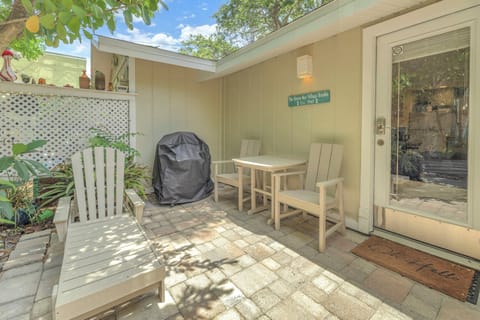 Charming private patio with chairs and grill, ideal for relaxing after a day at Siesta Key Beach.