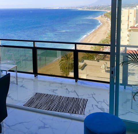 Big balcony with 2 seating groups overlooking the ocean.