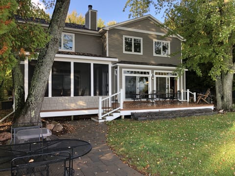 Spacious, grassy yard next to beach for playing games or sitting in this sun.