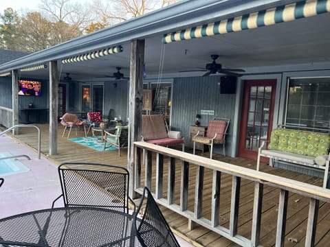 Back porch/deck with plentiful seating & large TV.