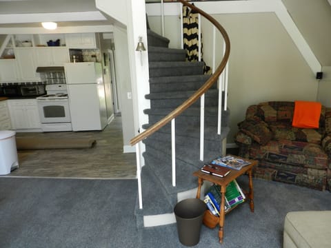 Porch umbrellas and outdoor rugs, baby gates behind staircase