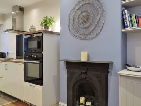 Feature fireplace within kitchen/diner | Riverholme, Bassenthwaite, near Keswick
