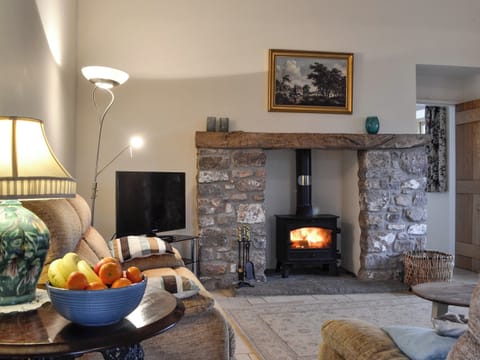 Living area with wood burner | The Old Byre, Middleton, near Swansea