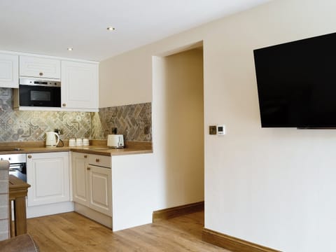 Wall-mounted TV | The Byres Tan - Stone House Farm Holiday Cottages, St Bees, near Whitehaven