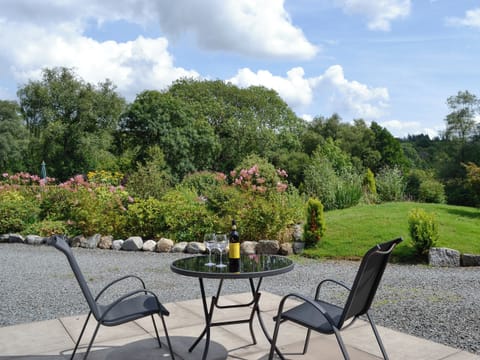 Sitting out area with lovely views over the garden | Wee Cordorcan - Cordorcan Cottages, Wood of Cree, near Newton Stewart