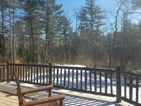 The decks view of the large yard and fire pit