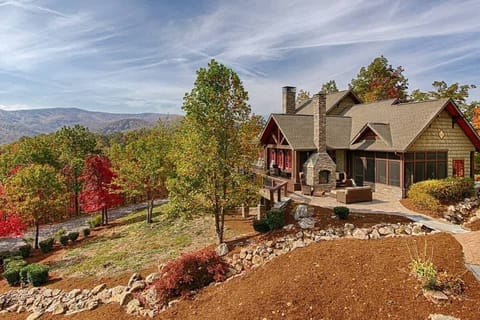 Side view with exterior double sided fireplace and comfortable outdoor furniture
