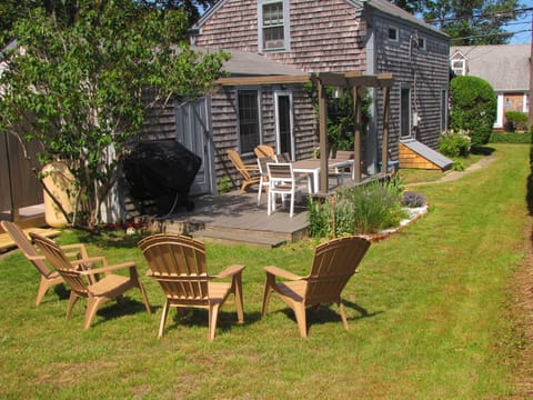 Relax on the adirondack chairs, large grassy yard, deck, gas grill