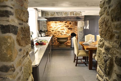 Ground floor: Kitchen through to dining room with original fireplace