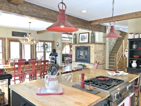Chef kitchen with gas fireplace and dinning room