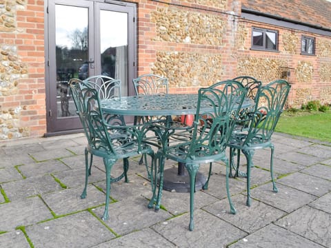 Paved patio with outdoor furniture | Baileys Barn - Moor Farm Stable Cottages, Foxley, near Fakenham