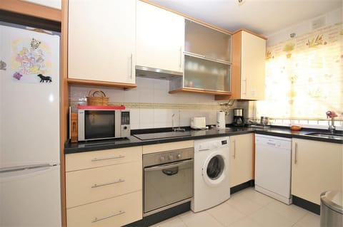 Kitchen in this apartment is fully equipped with all the appliances