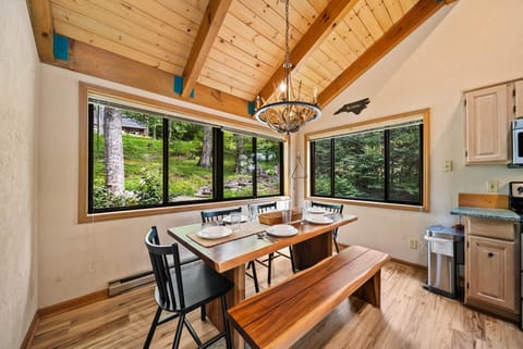 Dining Table Seats Six with Antler Chandelier and Big Windows