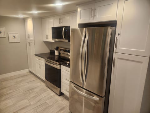 New stainless appliances with pantry (left) and broom closet (right)