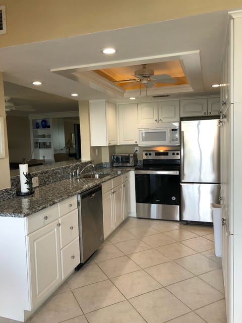 Looking through kitchen into living room and office area 